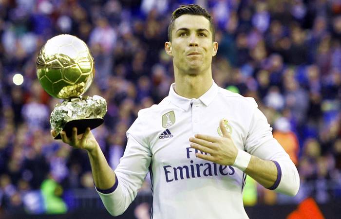 Cristiano Ronaldo in Real Madrid celebrating with his Ballon d'or award